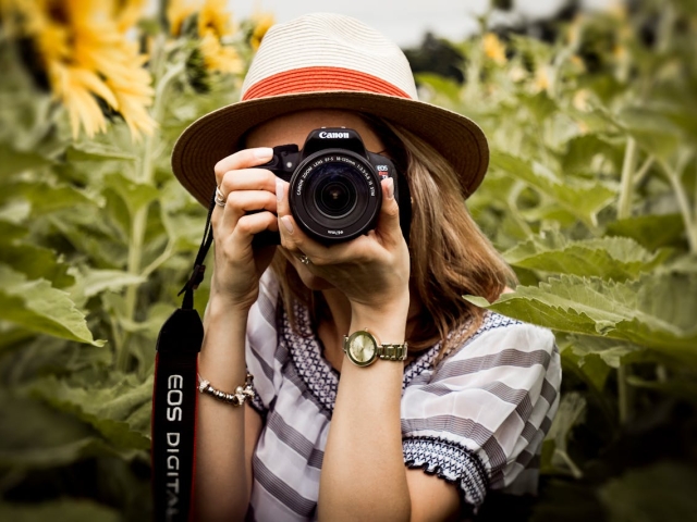 photography-of-woman-holding-dslr-camera